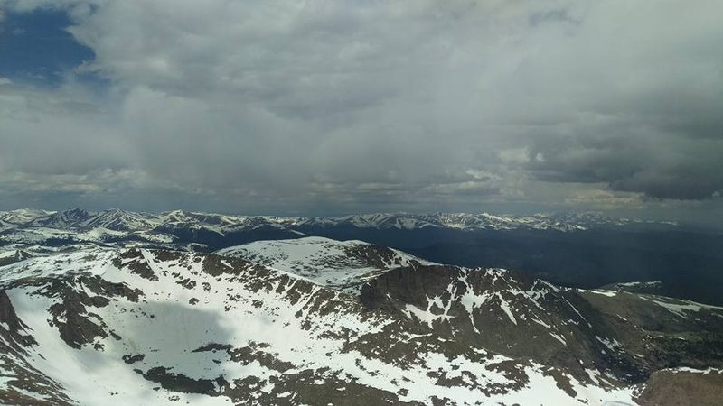 Snow-covered mountain peaks seen from the summit of Mount Blue Sky, Colorado