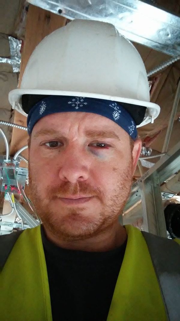 Robert Jenkins in a hard hat and safety vest on an electrical job site
