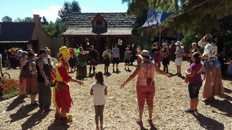 A jester leading a circle dance at the Colorado Medieval Festival