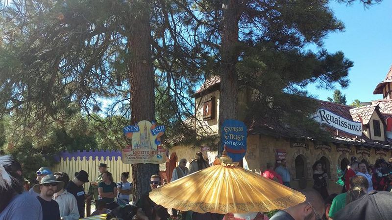 Golden parasol beside the Renaissance gate at the Colorado Medieval Festival