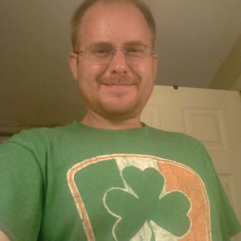 Robert Jenkins smiling in a green shamrock T-shirt on St. Patrick's Day